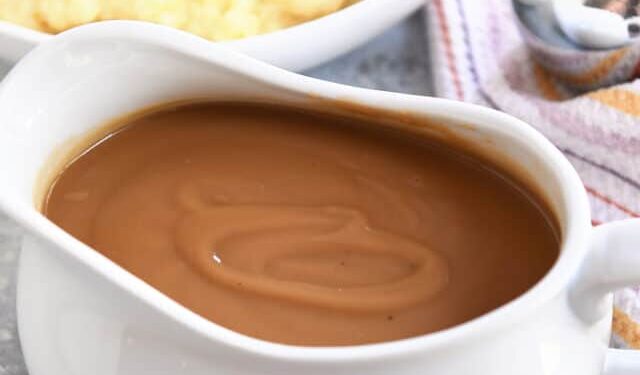 Gravy boat filled with brown gravy.