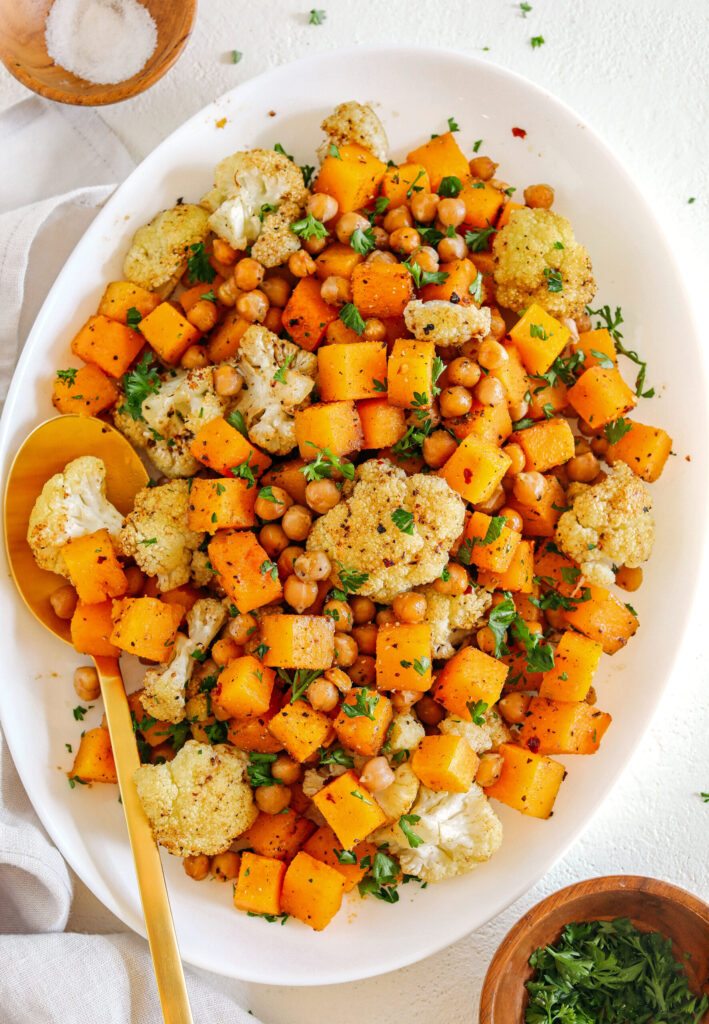 Roasted squash, cauliflower and chickpeas are perfectly seasoned and cooked in a single pan for an easy, delicious and healthy side dish the whole family will love.