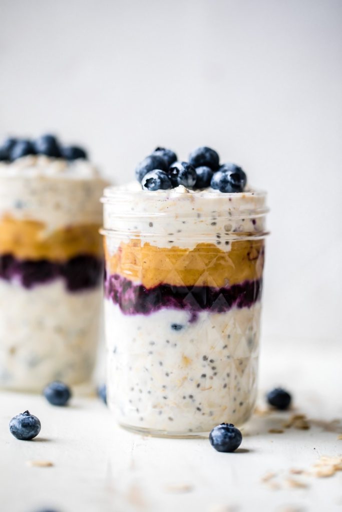 peanut butter blueberry overnight oats in two jars