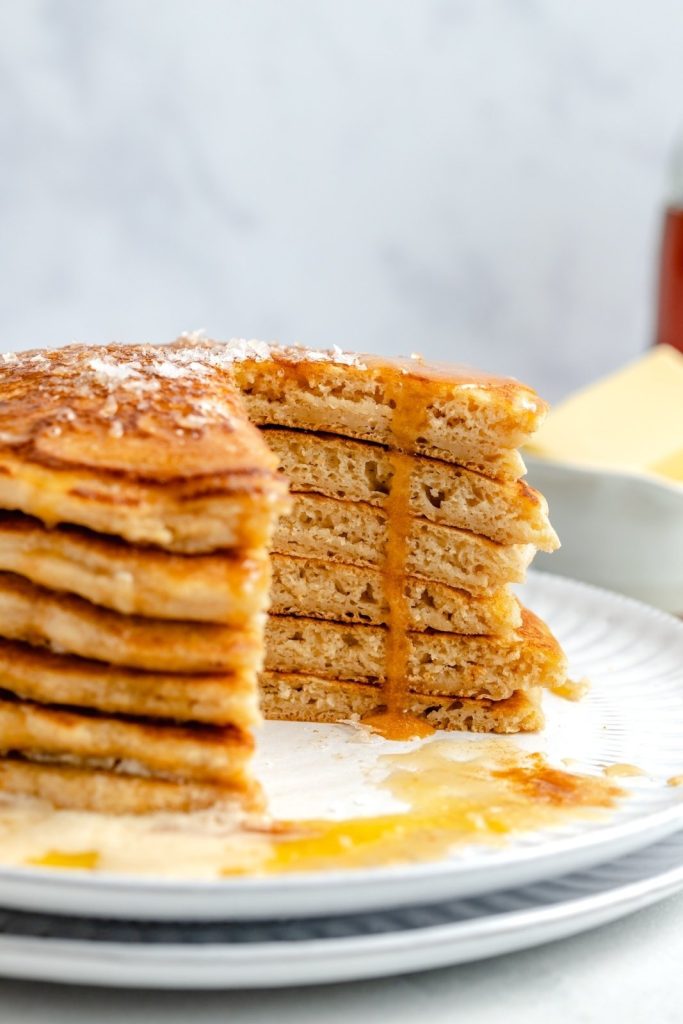 brown butter pancakes in a stack with a slice cut out