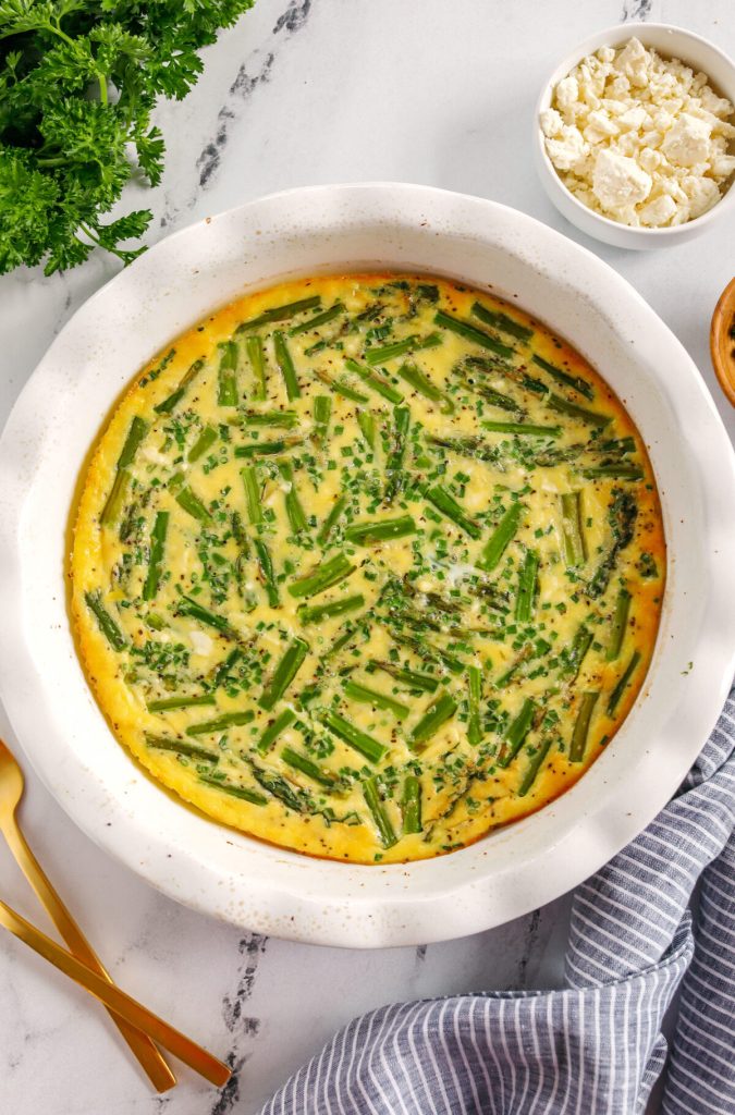 This healthy Asparagus and Feta Crustless Quiche is easily made with just a few simple ingredients, tastes delicious and makes the perfect low-carb dish you can enjoy for any meal!