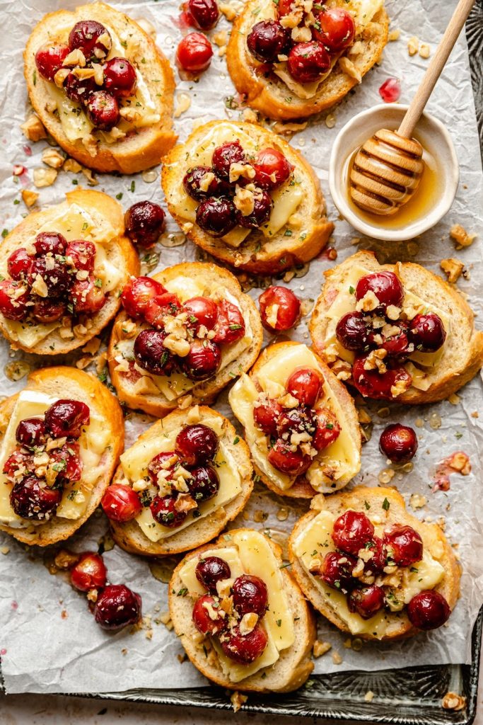 roasted grape and brie crostini on a baking sheet