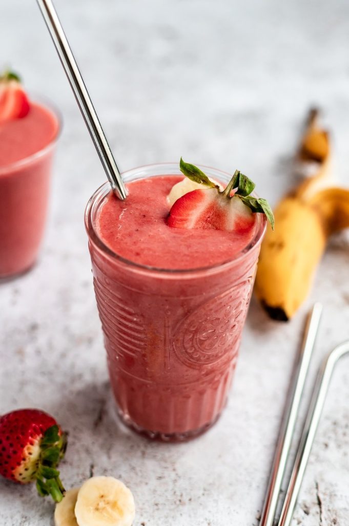 strawberry orange banana smoothie in a glass