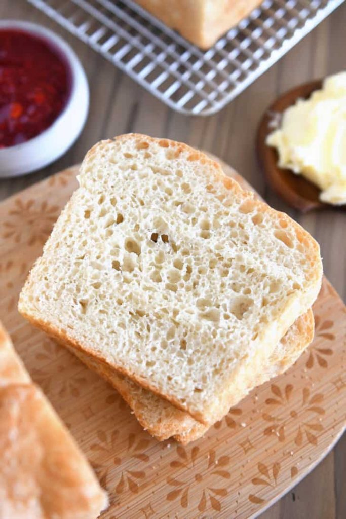 Slice of English muffin bread on wood cutting board.