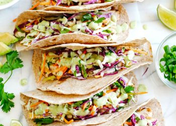 Easy and delicious Cilantro Lime Chicken Tacos topped with tangy coleslaw and homemade avocado crema make the perfect EASY summer recipe!  Full of fresh flavors and healthy ingredients!
