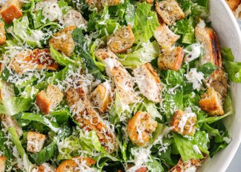 The BEST Healthy Chicken Caesar Salad made with grilled lemon chicken, garlicky homemade croutons, fresh parmesan cheese and tossed with a lightened up Greek yogurt dressing!