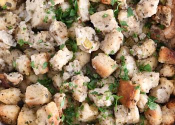 Top down view of baked stuffing and fresh parsley.