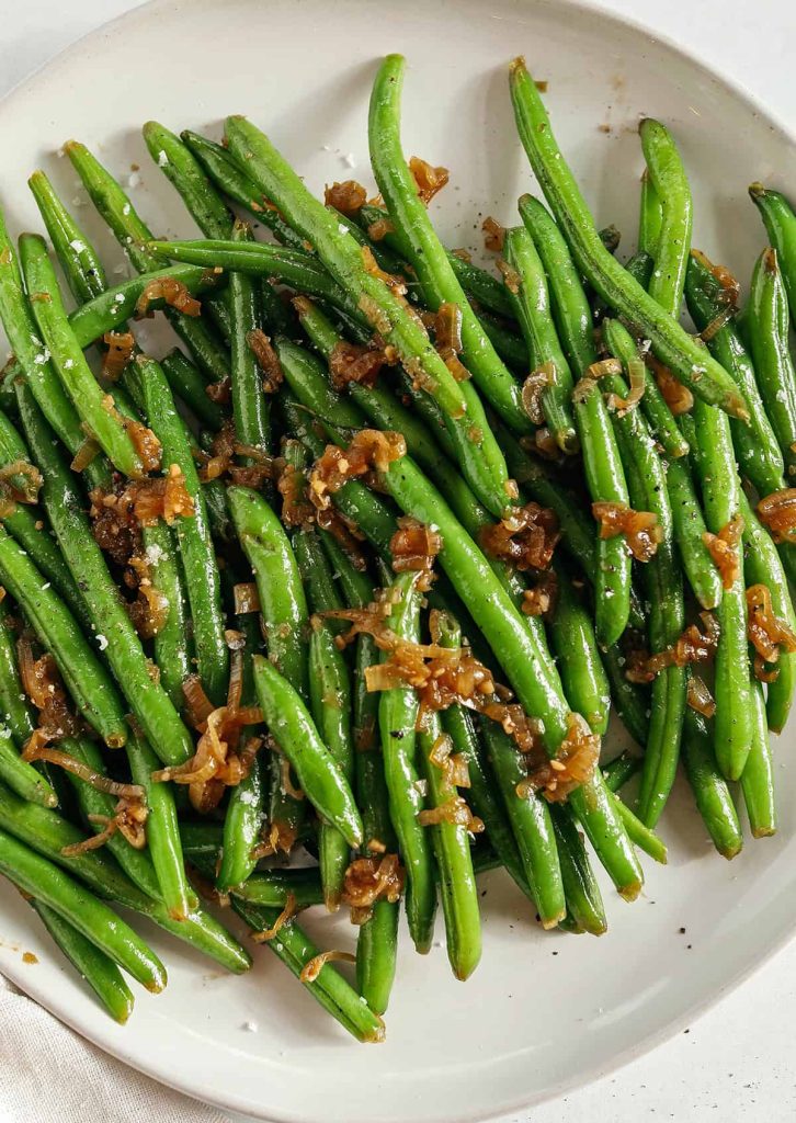 These fresh and crisp Garlicky Green Beans with Caramelized Shallots are a simple, healthy and flavorful side dish that comes together in just 15 minutes! No blanching necessary.  Perfect for busy weeknights or served with a holiday meal.