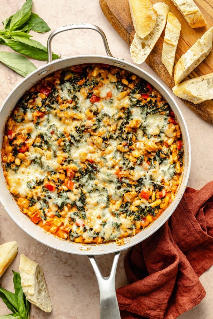 one pan chicken sausage white bean bake in a skillet