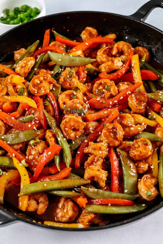 This Easy Firecracker Shrimp Stir Fry is the perfect weeknight meal with tender shrimp, crisp vegetables, all smothered in a sweet and spicy sauce that tastes way better than take-out! Serve over rice and have dinner on your table in under 20 minutes. 