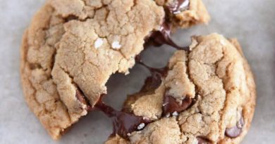 Top down view of chocolate chip cookie pulled in half with melty chocolate chips.