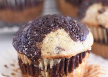 Unwrapped banana chocolate muffin on muffin liner.