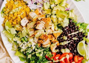 The BEST Southwest Chicken Salad with Creamy Avocado Dressing! Made with colorful veggies, marinated grilled chicken, black beans, corn, crumbled cotija cheese and tossed with the most delicious avocado cilantro dressing!