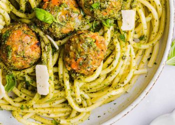 Mouthwatering Baked Chicken Pesto Meatballs made with tender ground chicken, garlicky basil pesto, fresh veggies and parmesan cheese. Juicy, flavorful and make the perfect weeknight meal served over pasta or with rice!