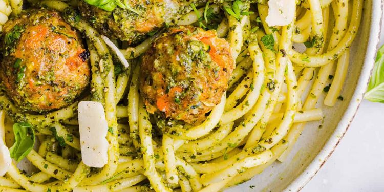 Mouthwatering Baked Chicken Pesto Meatballs made with tender ground chicken, garlicky basil pesto, fresh veggies and parmesan cheese. Juicy, flavorful and make the perfect weeknight meal served over pasta or with rice!