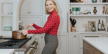 Monique of Ambitious Kitchen stirring a pot on the stove in her kitchen