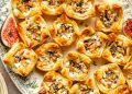 goat cheese puff pastry bites with fig jam on a platter
