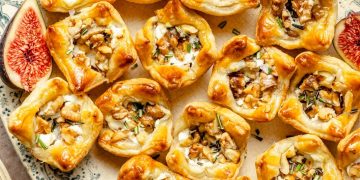 goat cheese puff pastry bites with fig jam on a platter