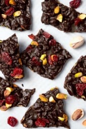 Pistachio and cranberry dark chocolate bark on countertop.