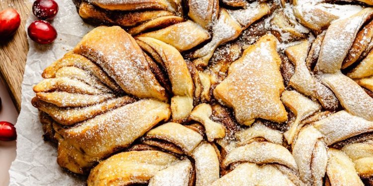 snowflake cinnamon roll on parchment paper