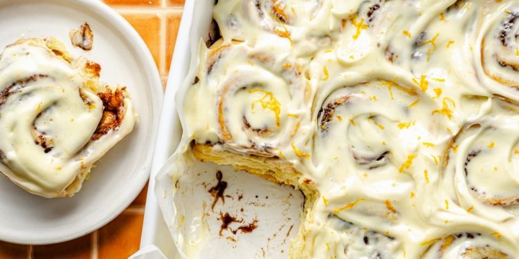 orange cinnamon rolls in a pan and on a plate
